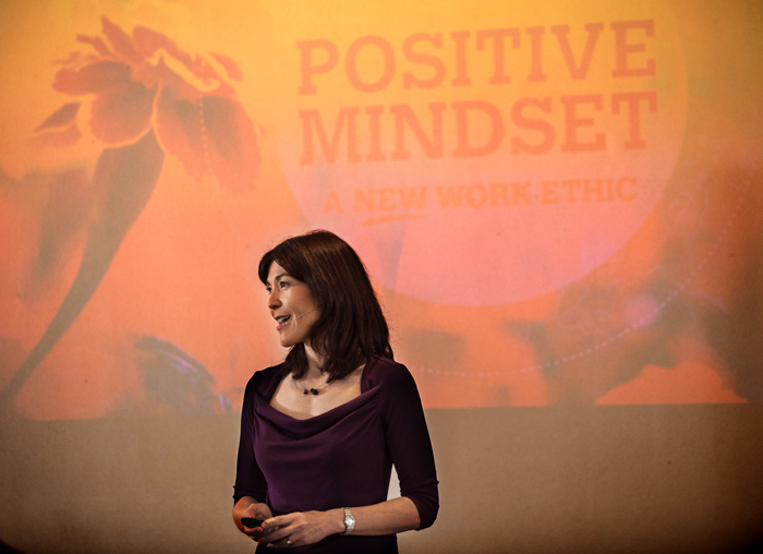 Alice Inoue standing in front of a projected screen with "Positive Mindset" written on it